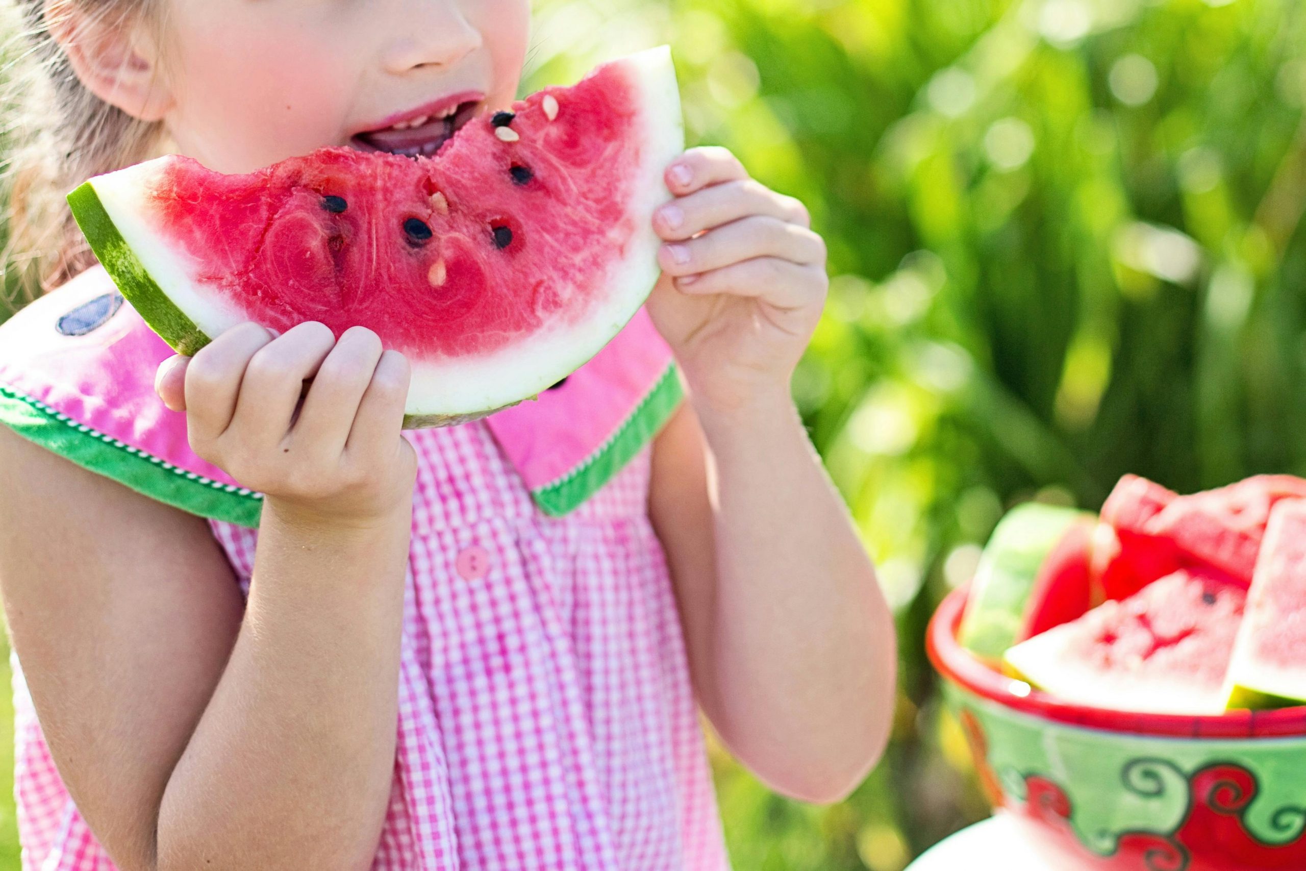 Child eating watermelon in summer