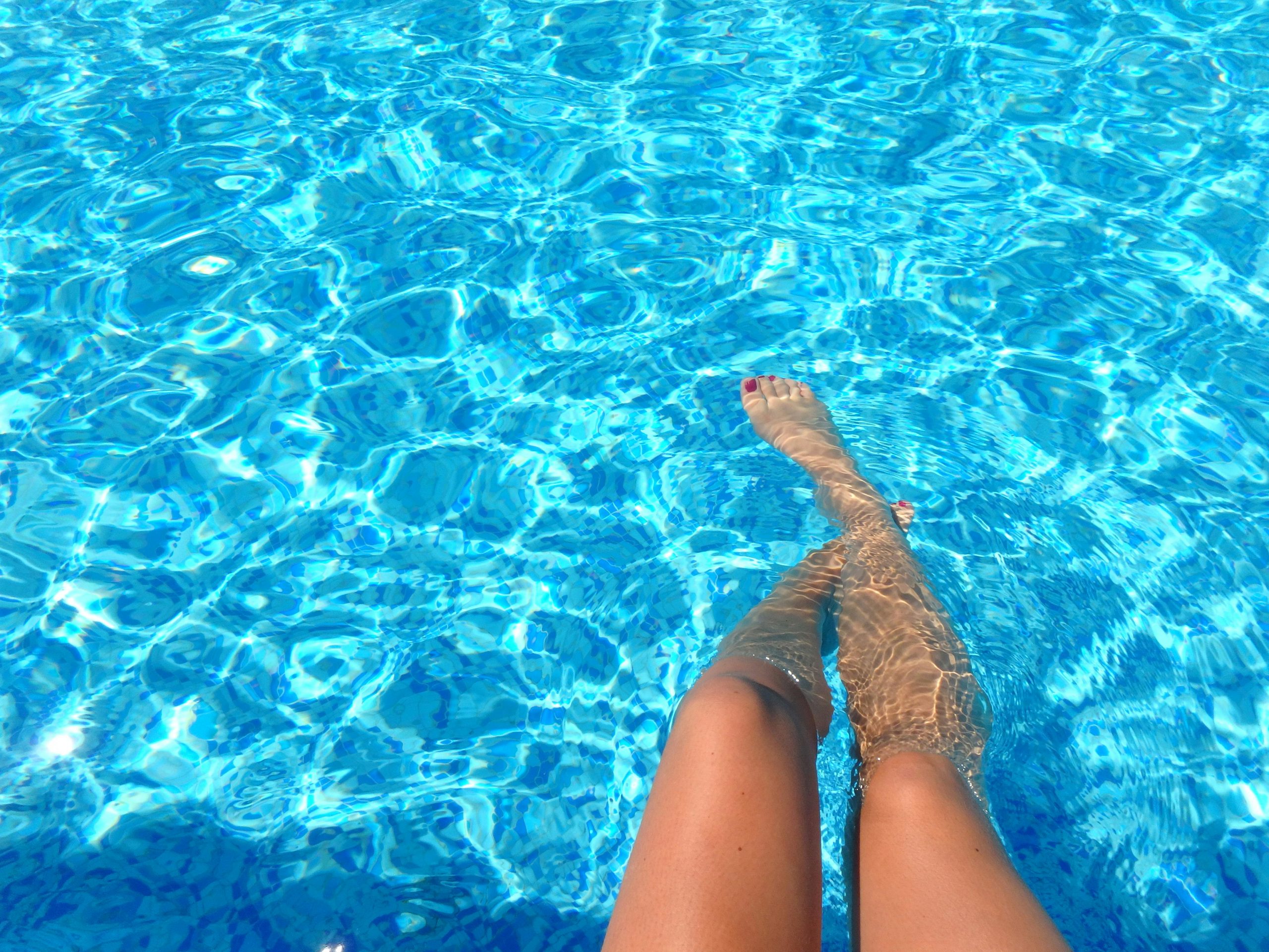 woman's legs in a swimming pool