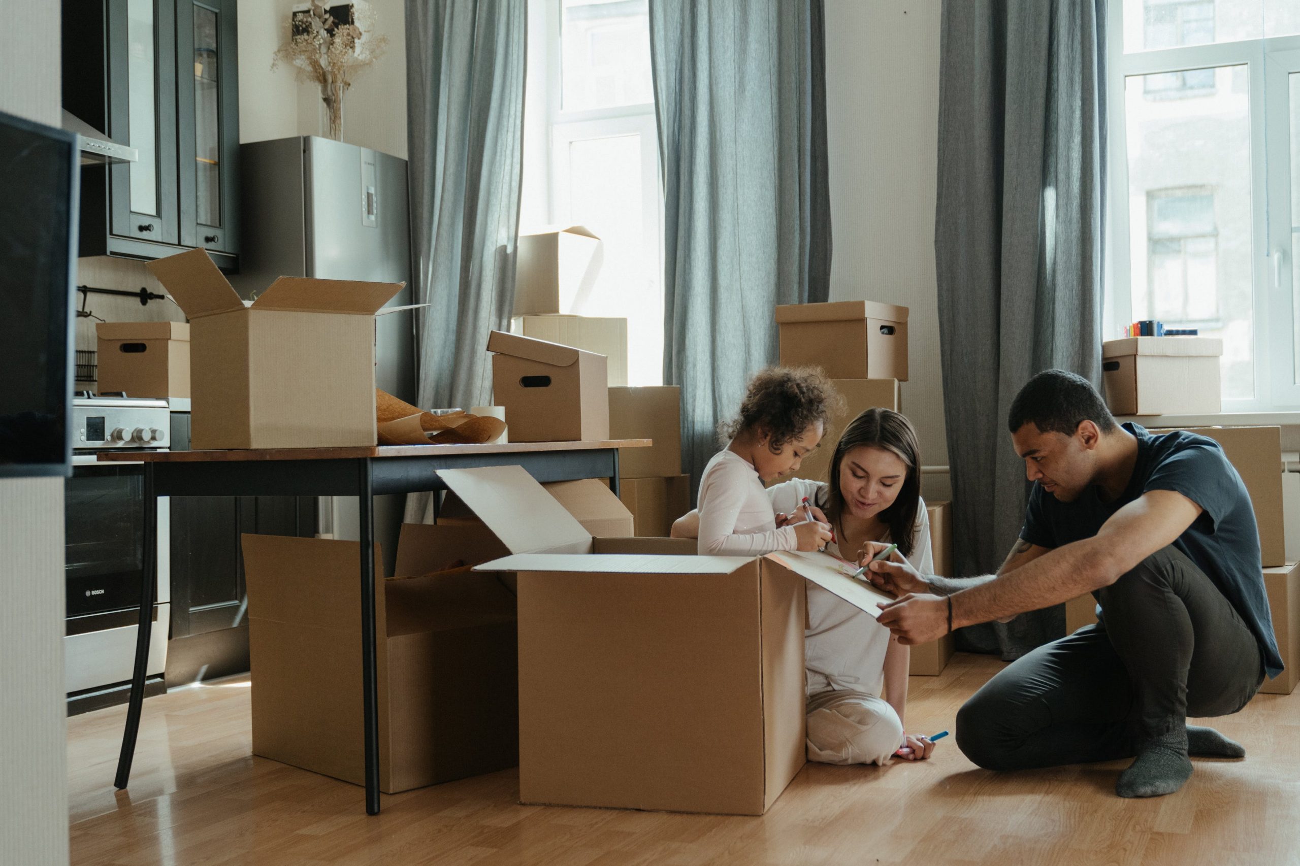 Family sitting amongst moving boxes