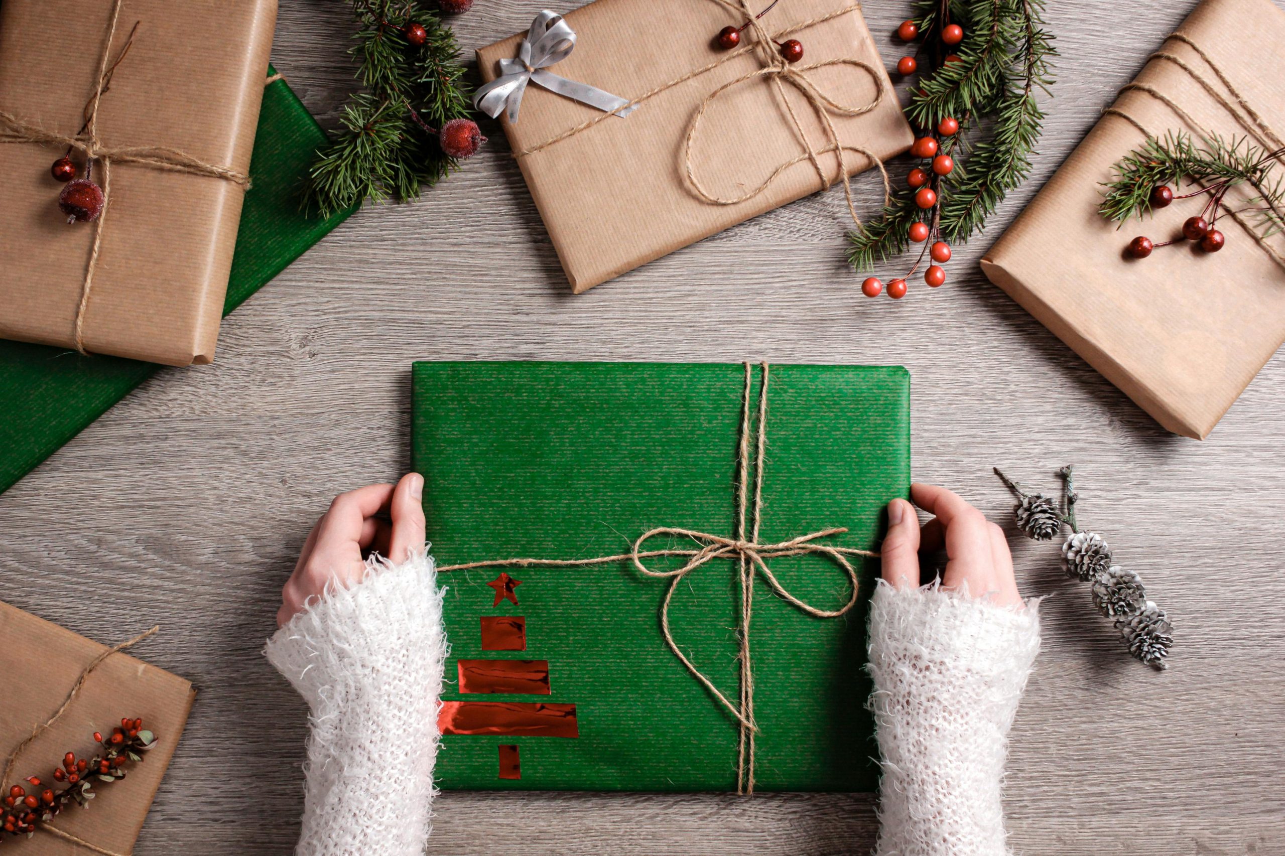 Hands holding a wrapped christmas present